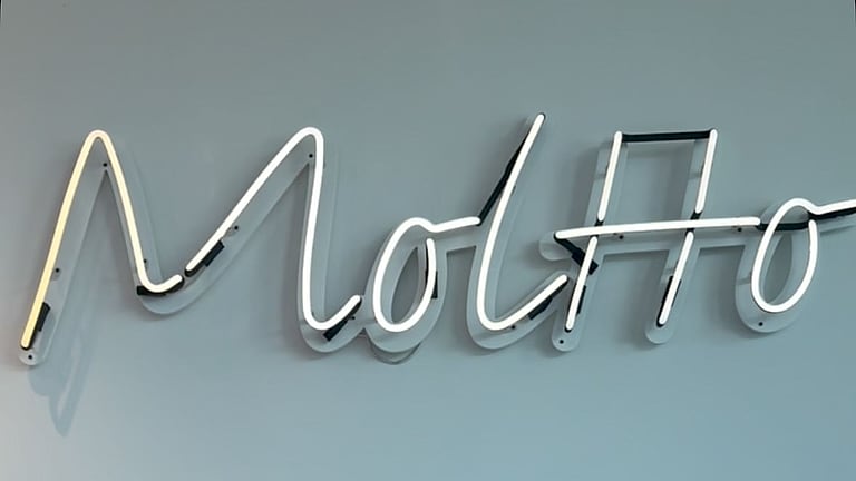 The Moltto neon sign above the bar
